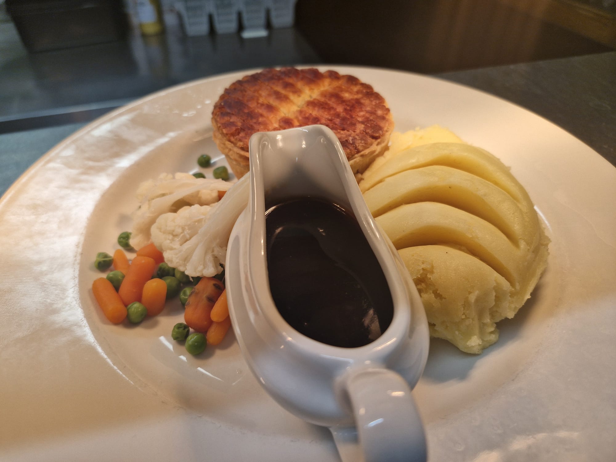Pie with mash vegetables and gravy